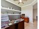 Spacious home office featuring a large desk, comfortable seating, and a view into the next room at 8100 Olive Brook Dr, Wesley Chapel, FL 33545