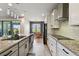 Kitchen features granite counters, stainless appliances, white cabinets and a breakfast nook overlooking the backyard at 8100 Olive Brook Dr, Wesley Chapel, FL 33545