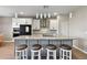 Kitchen showcasing granite counters, stainless appliances, white cabinets, island with seating and pendant lighting at 8100 Olive Brook Dr, Wesley Chapel, FL 33545