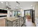 Kitchen showcasing granite counters, stainless appliances, white cabinets, island with seating and breakfast nook at 8100 Olive Brook Dr, Wesley Chapel, FL 33545