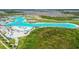 Wide aerial shot of a lagoon surrounded by beautiful community landscaping at 8100 Olive Brook Dr, Wesley Chapel, FL 33545