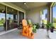 Screened patio with sliding glass doors, outdoor chairs, and view to the outside at 8100 Olive Brook Dr, Wesley Chapel, FL 33545