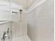 Modern tiled shower with a rainfall shower head and built-in niche for toiletries providing a spa-like experience at 8100 Olive Brook Dr, Wesley Chapel, FL 33545