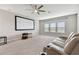 Spacious theater room with a ceiling fan, a large screen, and reclining leather seating at 8100 Olive Brook Dr, Wesley Chapel, FL 33545