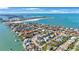 Breathtaking aerial view showcasing the coastal neighborhood, the ocean, and white sandy beach at 816 Ponce De Leon Dr, Tierra Verde, FL 33715