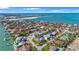 Stunning aerial view of homes nestled amongst lush greenery, with the ocean visible in the background at 816 Ponce De Leon Dr, Tierra Verde, FL 33715