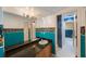 Bathroom with white and blue walls, dark granite countertop, and floral wallpaper at 816 Ponce De Leon Dr, Tierra Verde, FL 33715