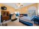 Cozy bedroom featuring blue and beige accent walls, a ceiling fan, and a wooden bed frame at 816 Ponce De Leon Dr, Tierra Verde, FL 33715