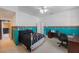 Vibrant bedroom showcasing blue accent walls, a ceiling fan, ample closet space, and warm lighting at 816 Ponce De Leon Dr, Tierra Verde, FL 33715