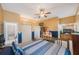 Comfortable bedroom featuring blue accent walls, a ceiling fan, ample closet space, and warm lighting at 816 Ponce De Leon Dr, Tierra Verde, FL 33715