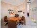 Cozy dining room featuring a wooden table, decorative lighting, and access to the staircase at 816 Ponce De Leon Dr, Tierra Verde, FL 33715