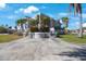 Beautiful home with an expansive driveway, manicured lawn, and lush landscaping at 816 Ponce De Leon Dr, Tierra Verde, FL 33715