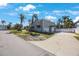 Lovely home exterior with a circular driveway, well-maintained landscaping, and an attached two-car garage at 816 Ponce De Leon Dr, Tierra Verde, FL 33715