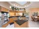 Well-lit kitchen with stainless steel appliances, granite countertops, cooktop island, and breakfast nook at 816 Ponce De Leon Dr, Tierra Verde, FL 33715
