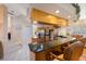Well-lit kitchen featuring an eat-in bar, stainless steel appliances, granite countertops, and white tile flooring at 816 Ponce De Leon Dr, Tierra Verde, FL 33715