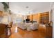 Open living room boasting hardwood floors, bright windows, a fireplace, built-in shelving, and kitchen access at 816 Ponce De Leon Dr, Tierra Verde, FL 33715