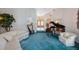 Comfortable living room with piano, harp, sofa, and access to main entrance at 816 Ponce De Leon Dr, Tierra Verde, FL 33715
