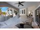 Covered patio with ceiling fan, comfortable seating, and outdoor grill at 816 Ponce De Leon Dr, Tierra Verde, FL 33715