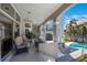 Covered patio with outdoor seating overlooking the pool and landscaped yard at 816 Ponce De Leon Dr, Tierra Verde, FL 33715