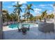 Backyard pool and spa with patio furniture and tropical landscaping at 816 Ponce De Leon Dr, Tierra Verde, FL 33715