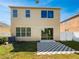 Backyard features a well-maintained lawn, patio area and exterior of the two-story home with clear blue skies at 8314 Deerland Bluff Ln, Riverview, FL 33578