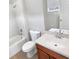 Bathroom featuring a tub-shower combo, a toilet and a single sink with a brown vanity at 8314 Deerland Bluff Ln, Riverview, FL 33578
