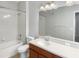 Bathroom featuring a tub-shower combo, a toilet and a single sink with a brown vanity at 8314 Deerland Bluff Ln, Riverview, FL 33578