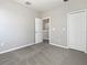 Bedroom features neutral walls, plush carpet, closet and open doorway that lets in ample natural light at 8314 Deerland Bluff Ln, Riverview, FL 33578