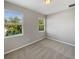 A gray bedroom with two windows, neutral paint and gray carpeting at 8314 Deerland Bluff Ln, Riverview, FL 33578