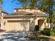 Two-story home with a two-car garage, a neutral color palette, and a well-maintained front yard at 8314 Deerland Bluff Ln, Riverview, FL 33578