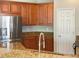 Kitchen with stainless steel appliances, granite countertops, wood cabinets and a white breakfast bar at 8314 Deerland Bluff Ln, Riverview, FL 33578
