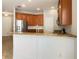 Kitchen with stainless steel appliances, granite countertops, wood cabinets and a white breakfast bar at 8314 Deerland Bluff Ln, Riverview, FL 33578
