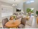 Bright living room with large windows, light gray walls, and contemporary furnishings at 8314 Deerland Bluff Ln, Riverview, FL 33578