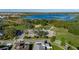 Beautiful aerial view captures the community's green space, clubhouse, parking, and access to a large lake at 9748 Ibis Grove Blvd, Wesley Chapel, FL 33545