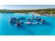 Enjoy an aqua park on the lagoon featuring thrilling slides, platforms, and attractions for hours of fun in a picturesque setting at 9748 Ibis Grove Blvd, Wesley Chapel, FL 33545