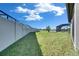 Spacious backyard with fence, featuring lush lawn and potential for outdoor activities at 9748 Ibis Grove Blvd, Wesley Chapel, FL 33545