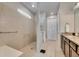 Bathroom with a large shower featuring bench seating and grab bars at 9748 Ibis Grove Blvd, Wesley Chapel, FL 33545