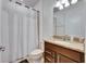 Full bathroom features a shower and a vanity with granite countertop at 9748 Ibis Grove Blvd, Wesley Chapel, FL 33545
