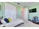 This bedroom includes a closet and a television mounted on the wall at 9748 Ibis Grove Blvd, Wesley Chapel, FL 33545