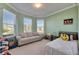 This room features a sunny bay window and playful green walls at 9748 Ibis Grove Blvd, Wesley Chapel, FL 33545