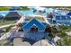 Explore the community clubhouse with its charming blue roof, inviting atmosphere, and convenient access to recreational amenities at 9748 Ibis Grove Blvd, Wesley Chapel, FL 33545