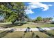 Scenic view of a community park with a playground, mature trees, and walking path for residents to enjoy at 9748 Ibis Grove Blvd, Wesley Chapel, FL 33545