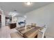 The dining area features tile floors, a wooden table with seating, and lots of natural light at 9748 Ibis Grove Blvd, Wesley Chapel, FL 33545