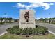 Welcome to Epperson! Community entrance featuring stone signage, lush landscaping, and modern lighting, inviting you to explore the area at 9748 Ibis Grove Blvd, Wesley Chapel, FL 33545