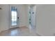 Spacious foyer featuring tile flooring and decorative glass front door at 9748 Ibis Grove Blvd, Wesley Chapel, FL 33545