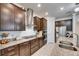 Modern kitchen featuring dark wood cabinets, stainless steel appliances, and granite countertops at 9748 Ibis Grove Blvd, Wesley Chapel, FL 33545