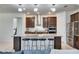 Bright, modern kitchen with a large island, pendant lighting, and stainless steel appliances at 9748 Ibis Grove Blvd, Wesley Chapel, FL 33545