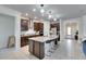 Modern kitchen boasts a large island with barstool seating, ideal for casual dining at 9748 Ibis Grove Blvd, Wesley Chapel, FL 33545