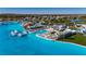 Gorgeous aerial view of the expansive lagoon pool with slides, tiki bars, dining, and lounging areas at 9748 Ibis Grove Blvd, Wesley Chapel, FL 33545