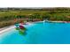 Serene turquoise lagoon with rows of colorful kayaks and canoes, perfect for water activities at 9748 Ibis Grove Blvd, Wesley Chapel, FL 33545